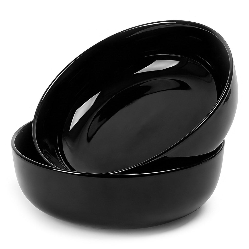Two nested glossy black opal glass bowls stacked together on a clean white background.