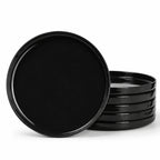 A set of glossy black round opal glass dinner plates, with one standing upright in front of a stack of five on a clean white background.