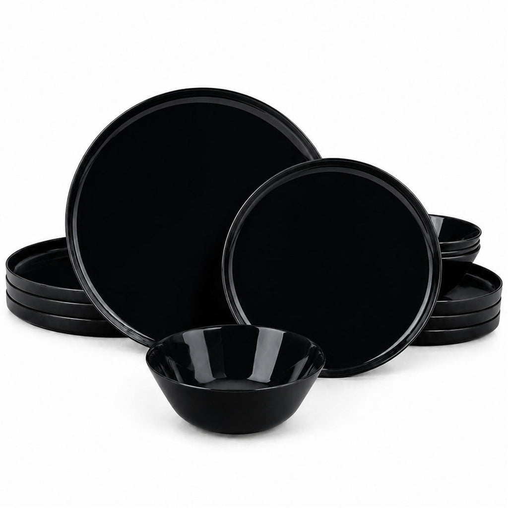 A set of glossy black opal glass dinnerware, including plates and bowls, arranged on a clean white background.