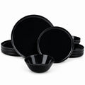 A set of glossy black opal glass dinnerware, including plates and bowls, arranged on a clean white background.